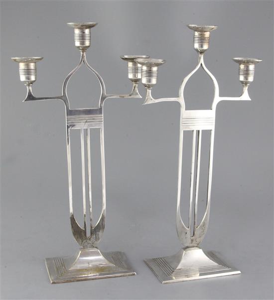 A pair of WMF Secessionist design silvered brass candelabra, height 16.5in.